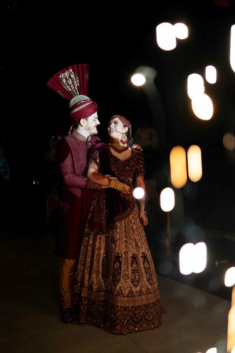 Bride and groom smiling at each other amid glowing bokeh lights at the reception, Adam & Sobia's wedding