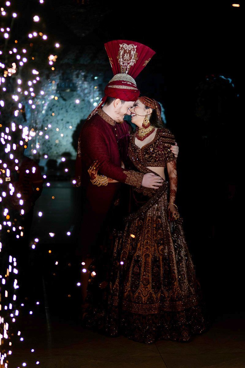 Bride and groom touching noses and laughing amid sparkling lights at the reception, Adam & Sobia's wedding