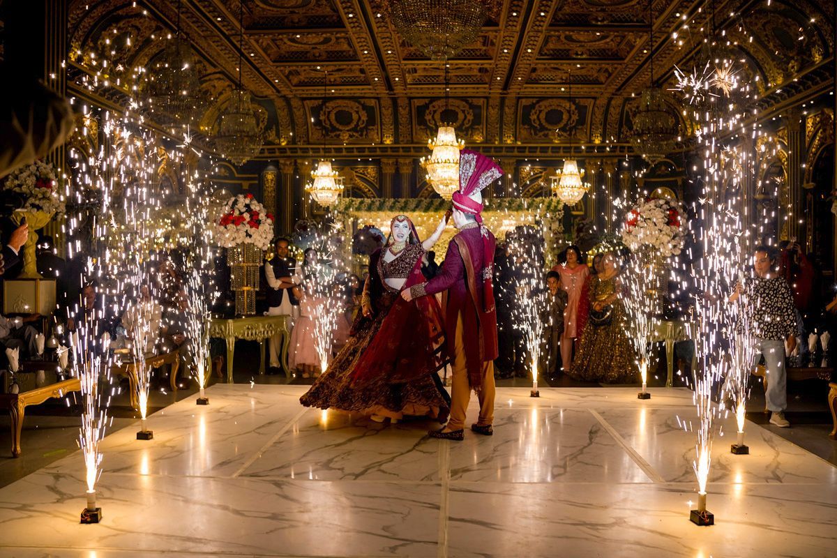 Wide shot of bride and groom dancing on the marble floor surrounded by fountains of cold-spark fireworks, Adam & Sobia's wedding