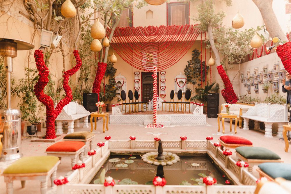 Wide shot of the haveli courtyard's floral nikah setup beside the lily pond fountain, Ahmed & Laraib's wedding at Barood Khana Haveli, Lahore