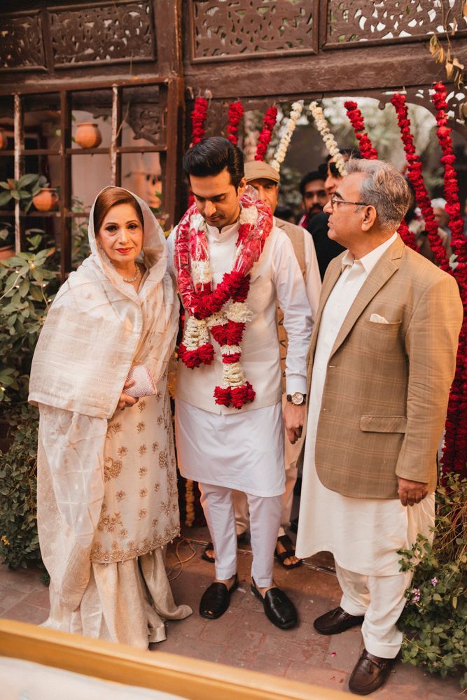 Groom arriving at the haveli wearing a flower garland, greeted by his parents, Ahmed & Laraib's wedding
