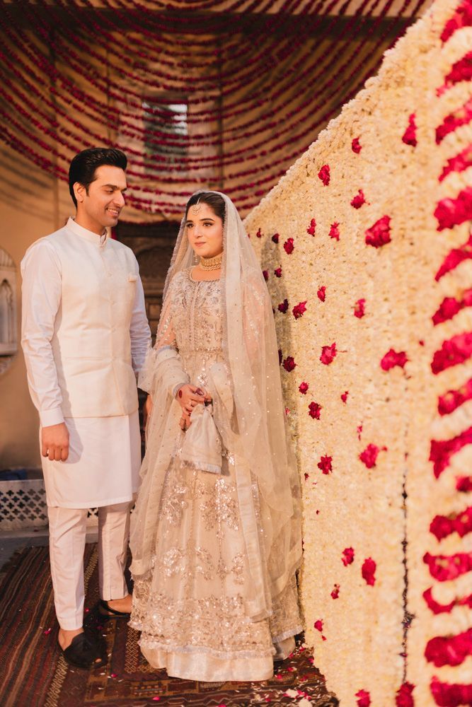 Bride and groom standing together by the fountain after the nikah ceremony, smiling at each other, Ahmed & Laraib's wedding