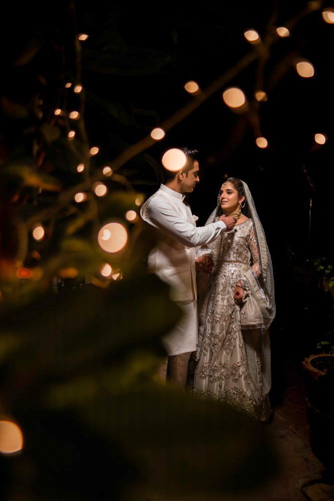 Bride and groom sharing a quiet moment at night beneath string lights, Ahmed & Laraib's wedding