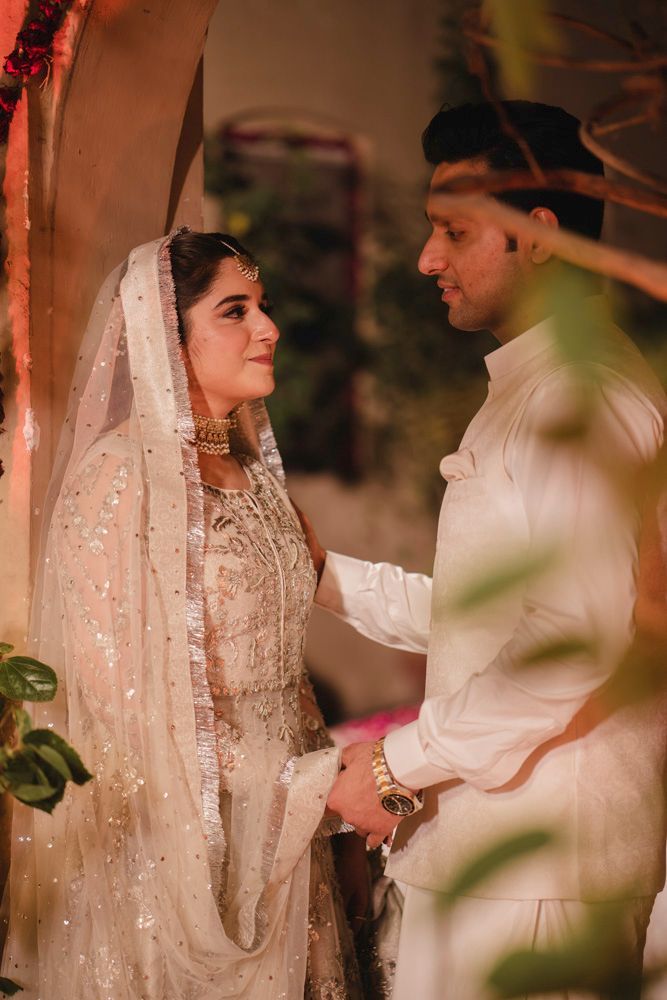 Bride and groom sharing a quiet moment at night, her hand on his arm, Ahmed & Laraib's wedding