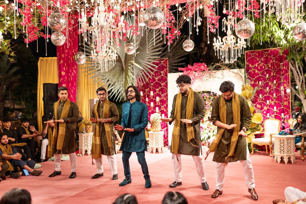 Groom and friends performing a dance routine on the mehndi stage, Maham & Aurangzeb's wedding