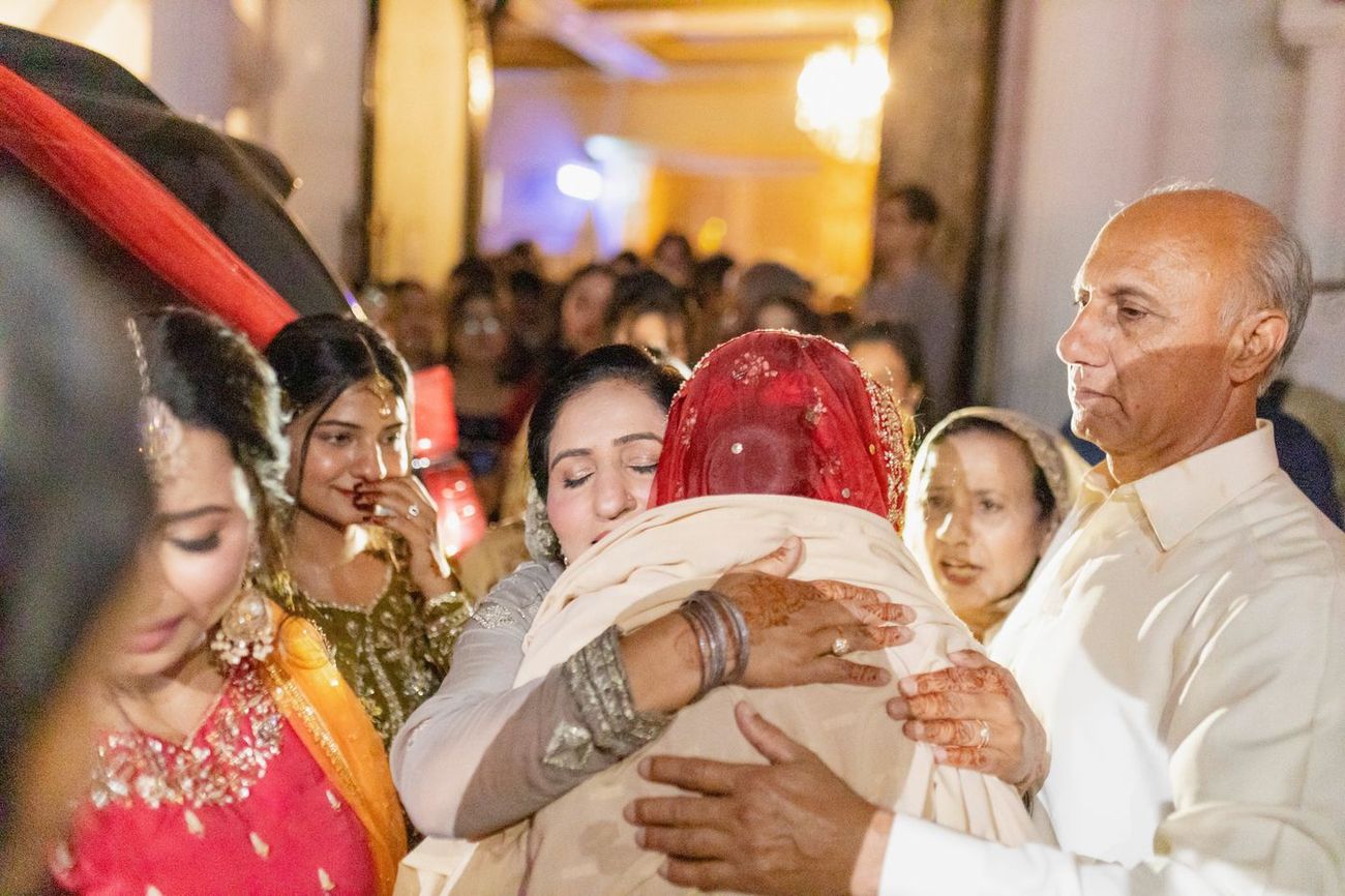 Emotional farewell embrace between the bride and a family member during the rukhsati departure, Maham & Aurangzeb's wedding