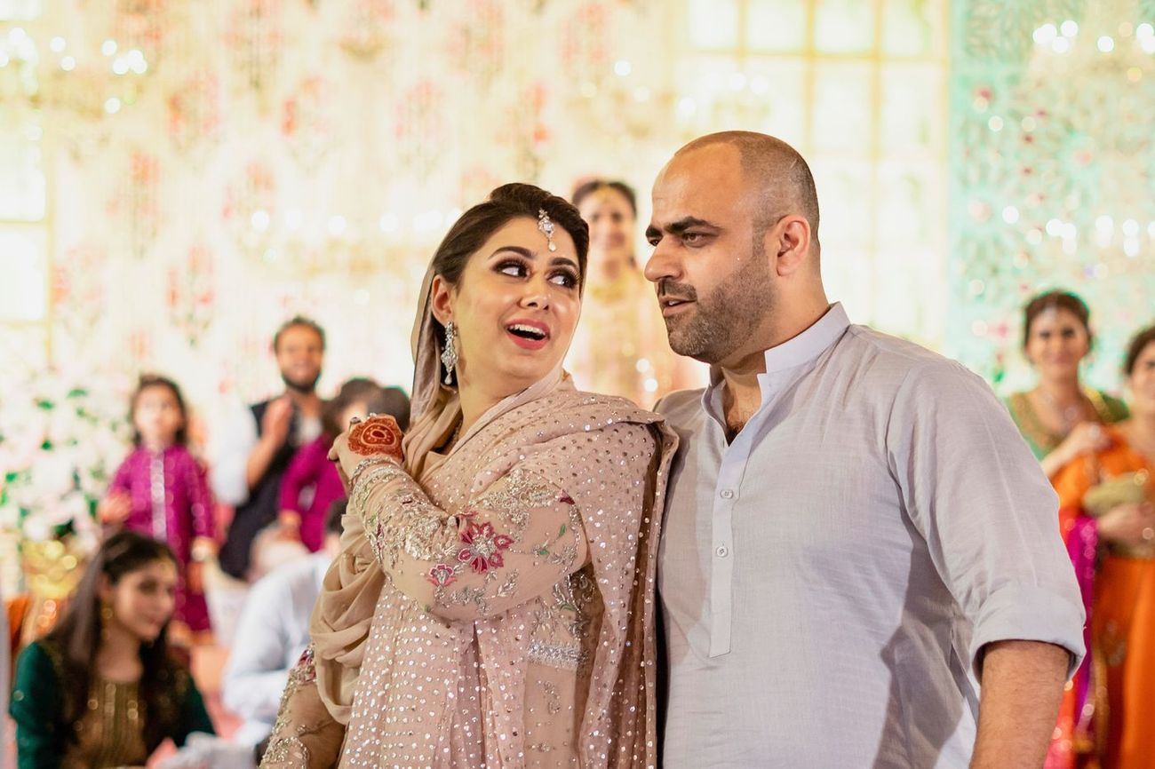 Candid moment between two family members laughing together at the mehndi, Mashal & Danial's wedding