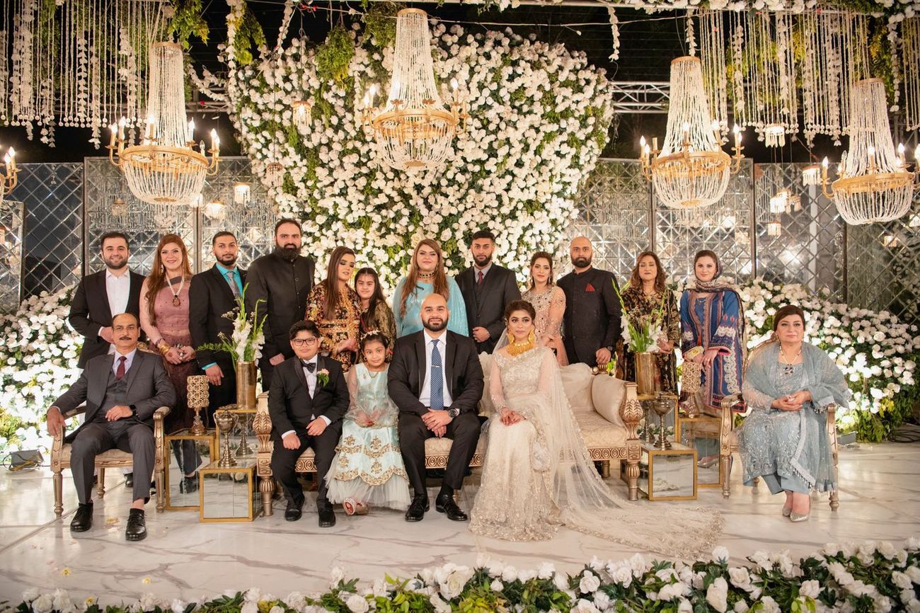 Extended family group portrait around the bride and groom at the walima reception, Mashal & Danial's wedding