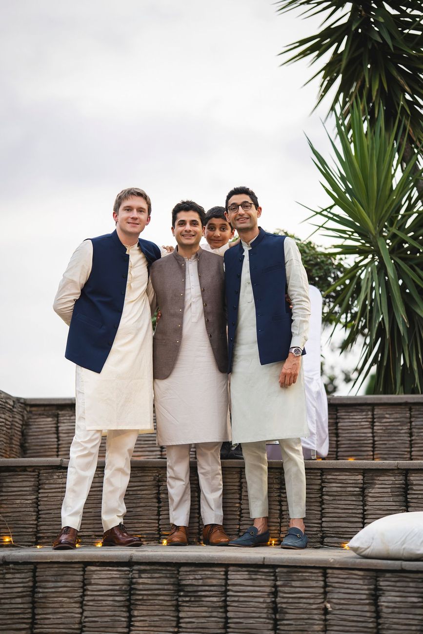 Groom with three groomsmen posing together on the garden steps, Nayha & Rafay's wedding in Islamabad