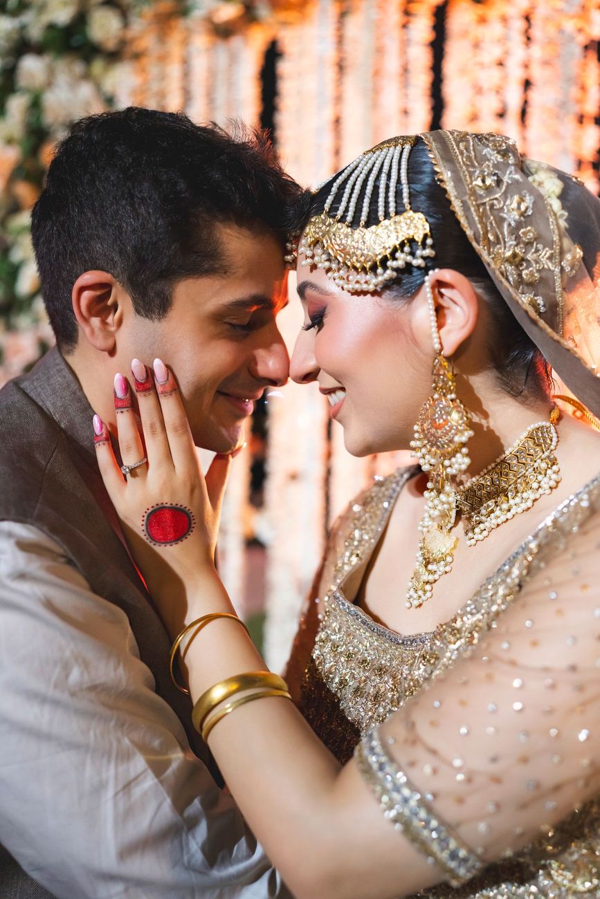 Close-up of bride and groom touching foreheads, her hand on his cheek showing her engagement ring, Nayha & Rafay's wedding in Islamabad
