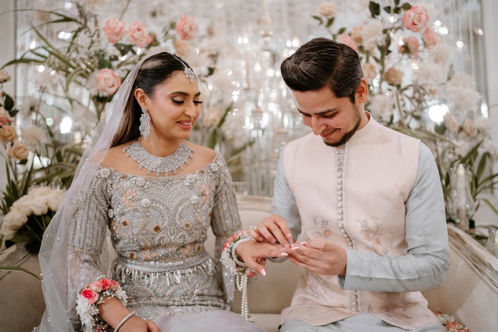 Close-up of the ring exchange between bride and groom, both smiling, Sheraz & Nawal's wedding at Nishat Hotel, Lahore