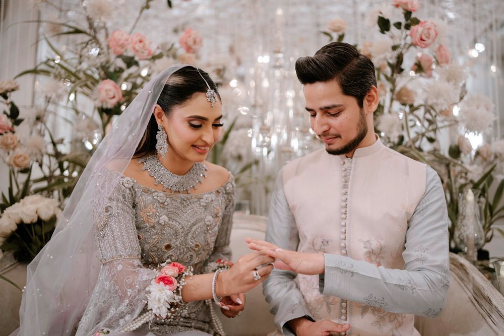 Close-up of bride and groom laughing together during the ring exchange, Sheraz & Nawal's wedding at Nishat Hotel, Lahore