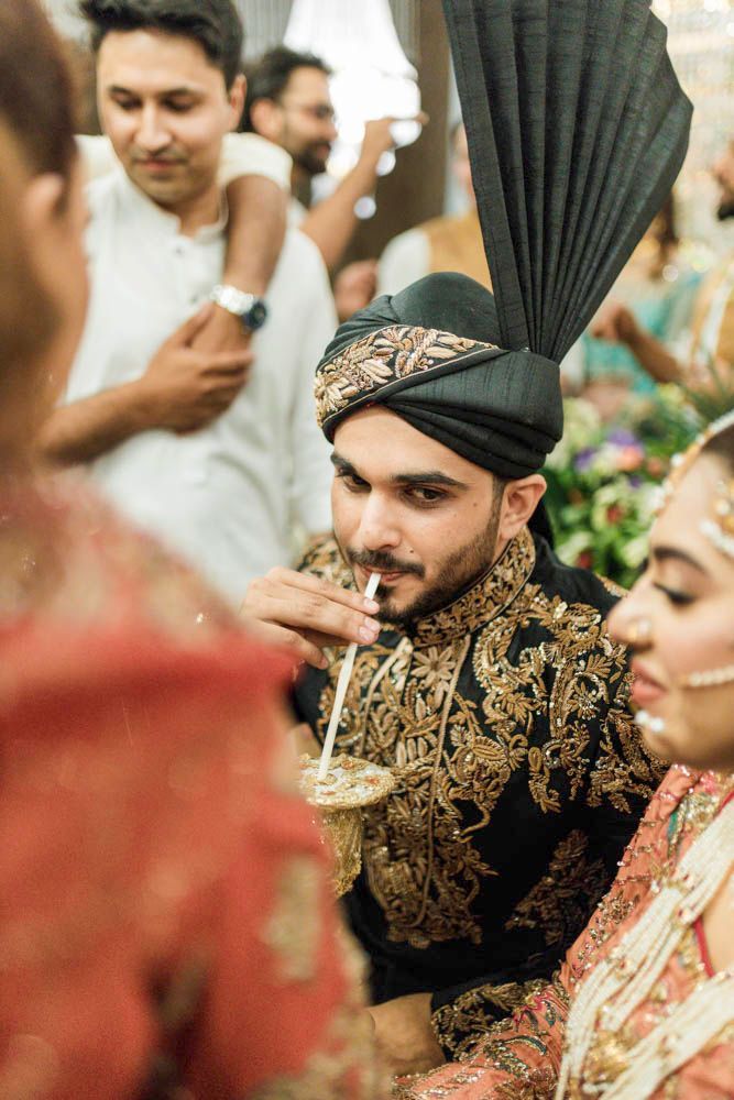 Groom sipping from the same ornate cup beside the laughing bride, Zara & Shuaib's wedding, Lahore