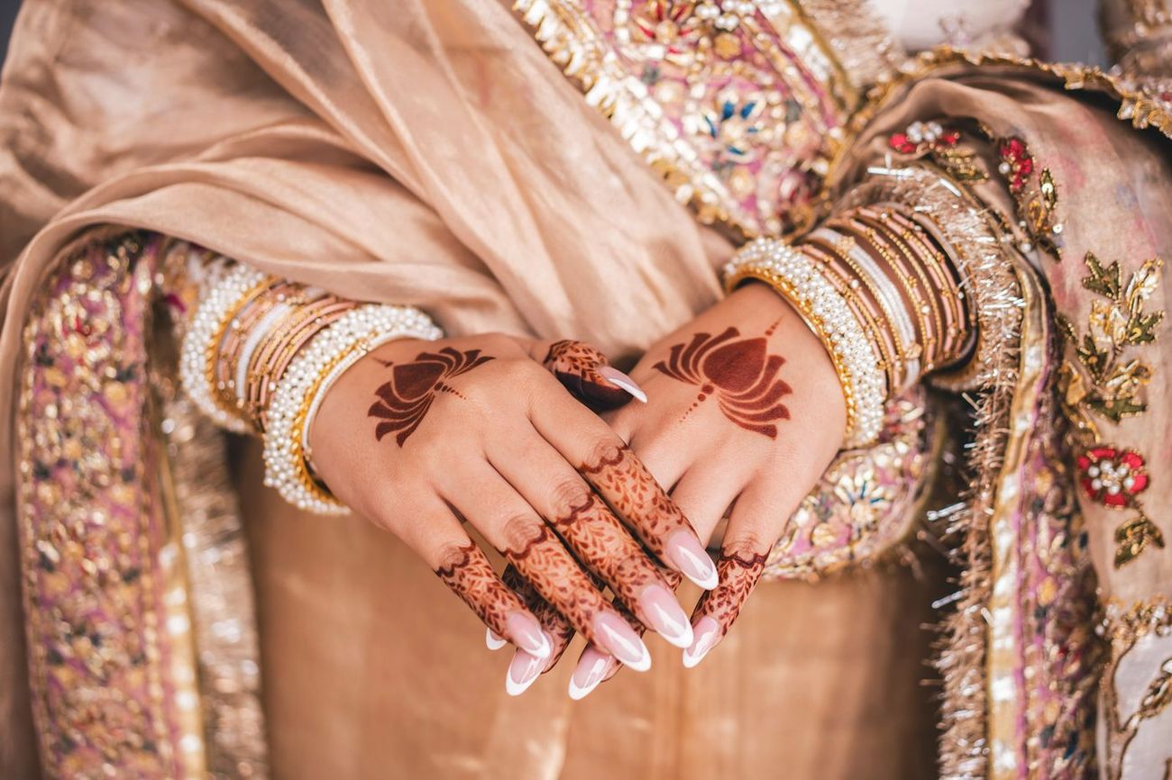 Close-up detail of the bride's henna and bangles
