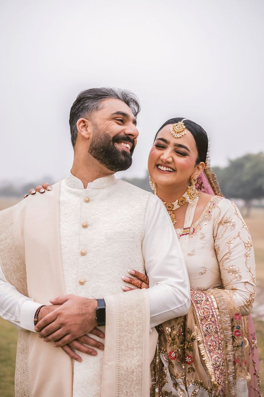 Close laughing portrait of the couple side by side on the misty field