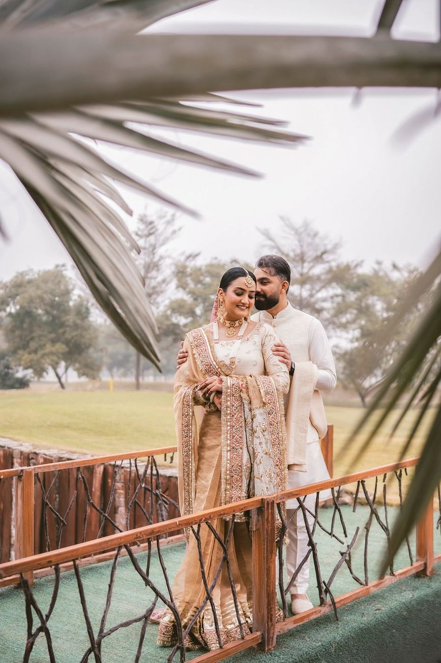 Couple sharing a quiet moment on the same wooden bridge