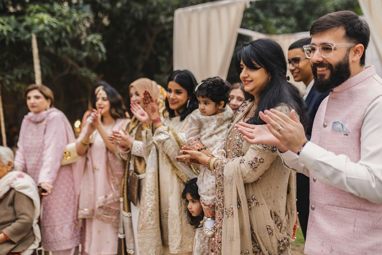 Guests of all ages clapping together during the ceremony