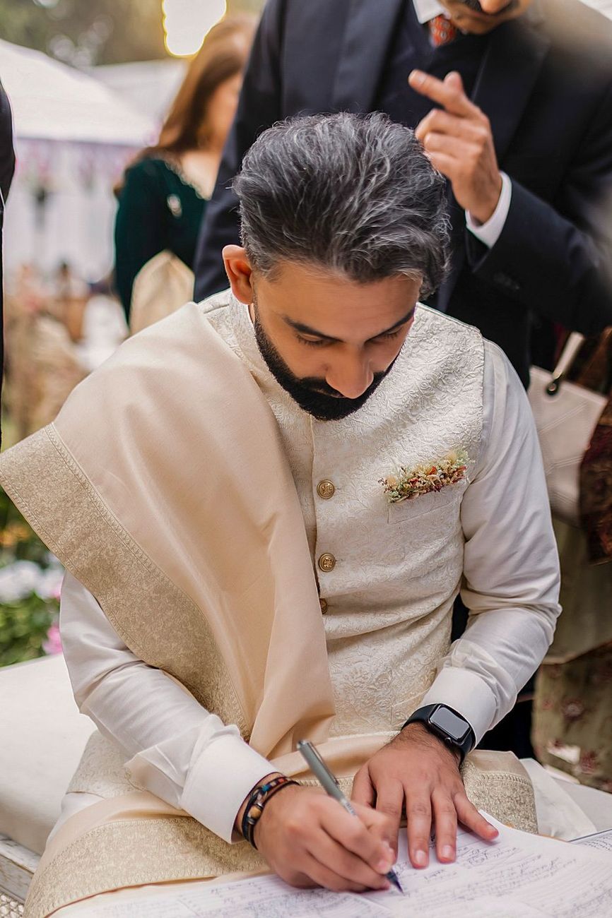 Groom signing the nikah documents
