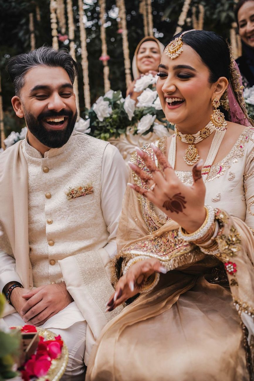 Bride happily showing off her ring, both laughing
