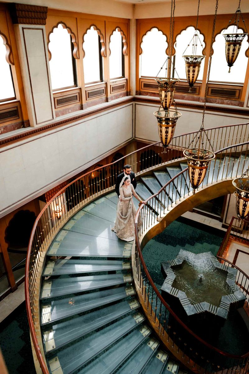 Couple on a curved staircase in a luxury venue