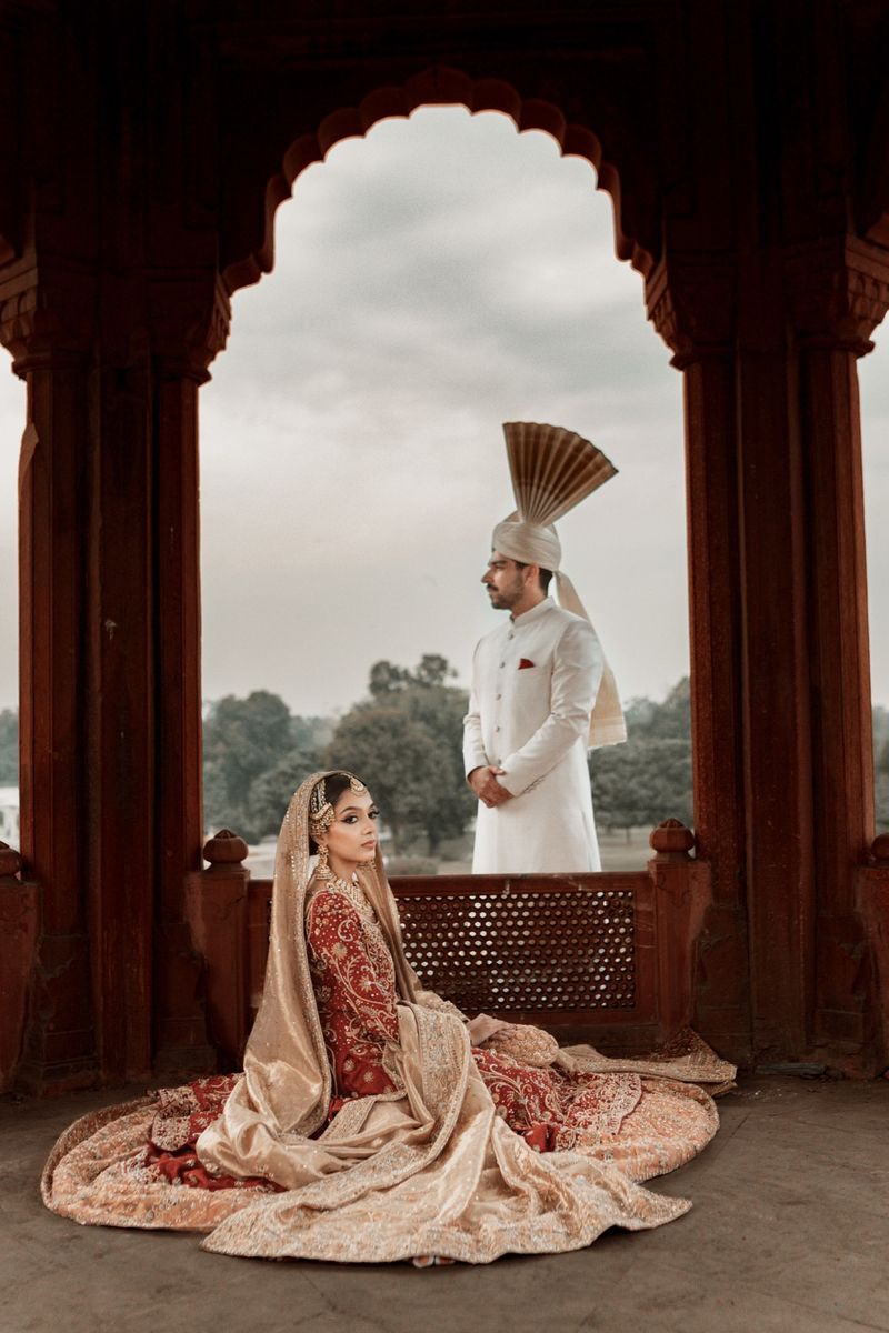 Bride and groom framed in heritage architecture