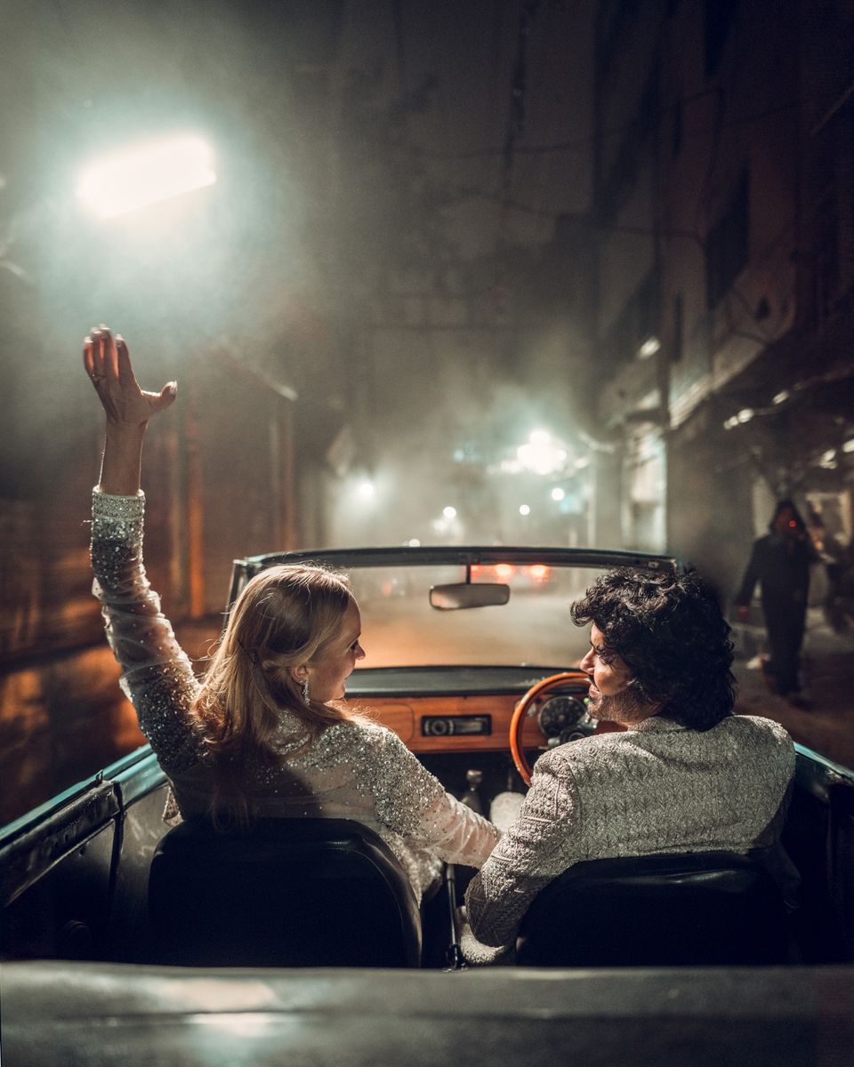 Couple in a vintage car at night