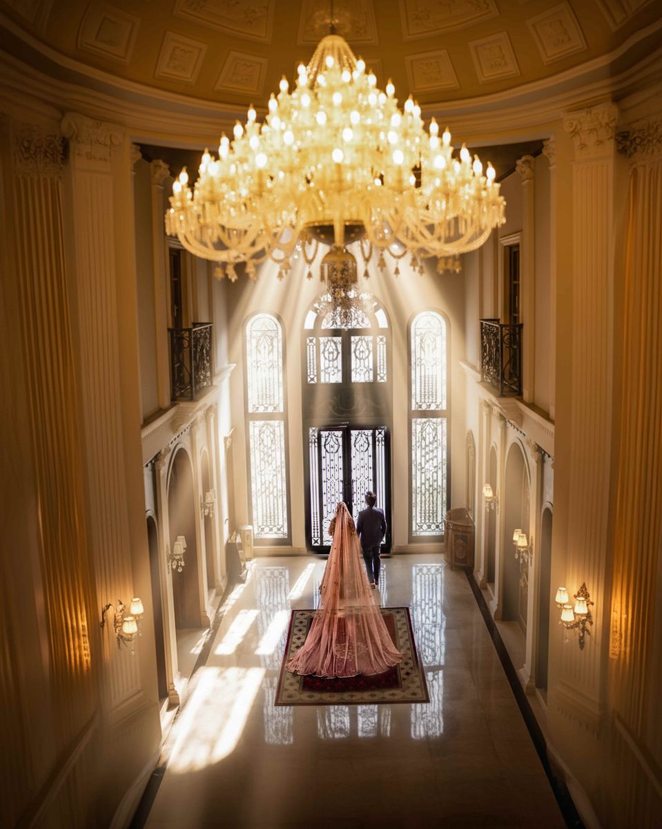 Bride beneath a chandelier in a grand hall